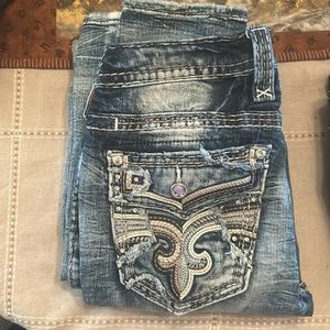 Like new distressed light wash rock revival jeans .